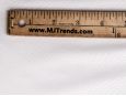 Closeup shot of white imitation snakeskin fabric with ruler to show scale. thumbnail image.