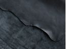 front and back side of black lambskin leather hide