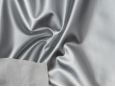 White backing shown on top of shiny metallic silver PVC vinyl material. thumbnail image.