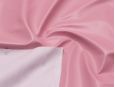 White backing shown on top of pastel pink stretch vinyl fabric. thumbnail image.