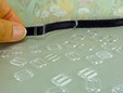 Clear plastic bra slide on a bra strap. thumbnail image.