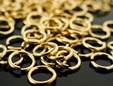 Upclose shot of gold jump rings for chain maille. thumbnail image.