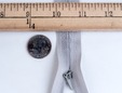 Macro shot of grey 9 inch nylon invisible zipper. thumbnail image.