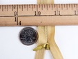 Macro shot of gold 20 inch invisible hidden zipper. thumbnail image.