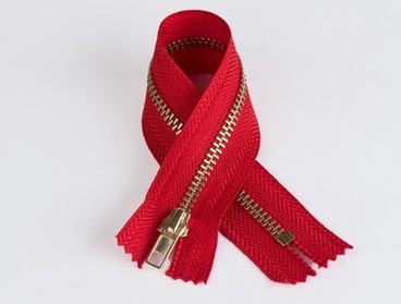 Red zipper with brass teeth - non-separating.
