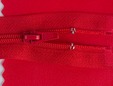 Red zipper on matching red faux leather. thumbnail image.