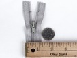 Upclose shot of 7 inch silver grey zipper. thumbnail image.