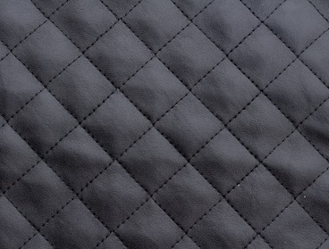 Black quilted faux leather fabric.